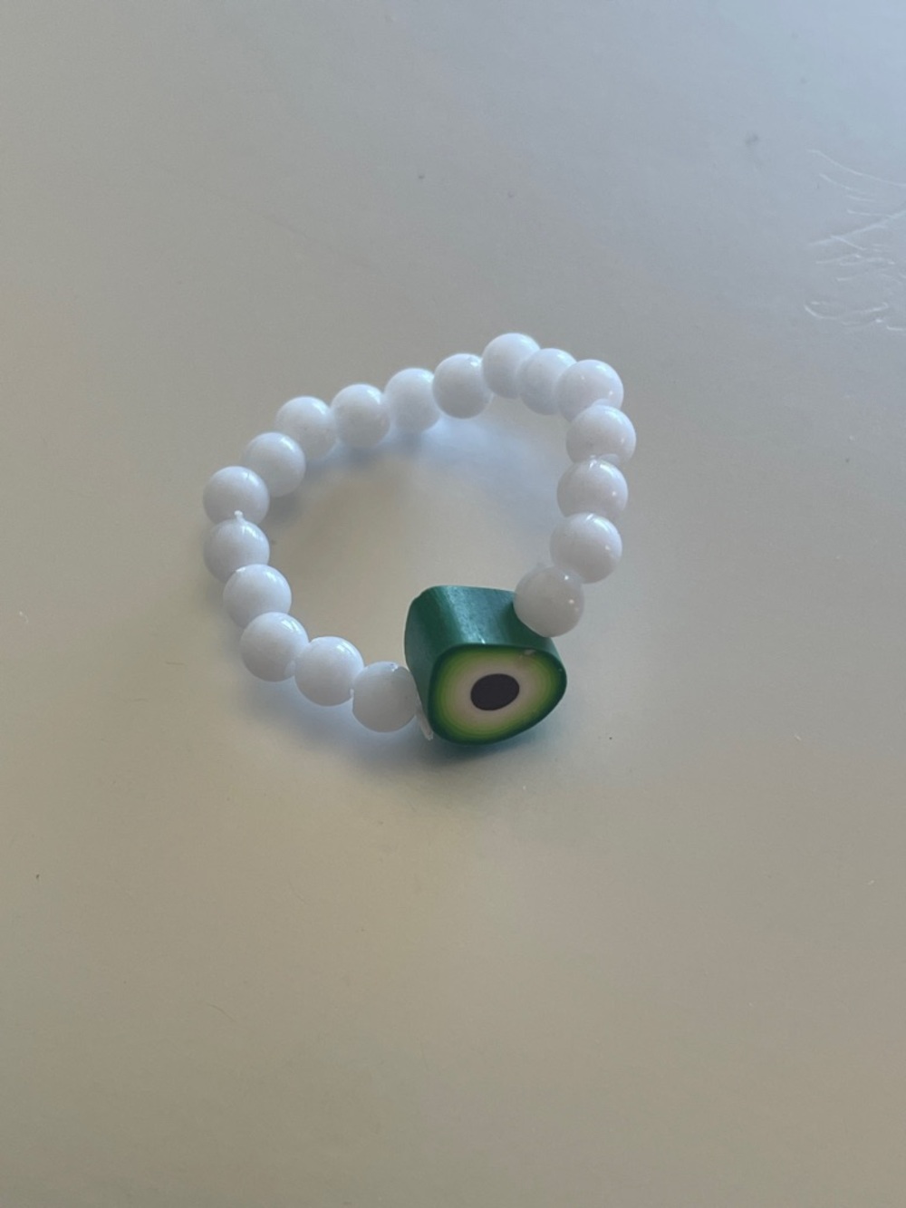 White Beaded Ring with Green Avocado Charm